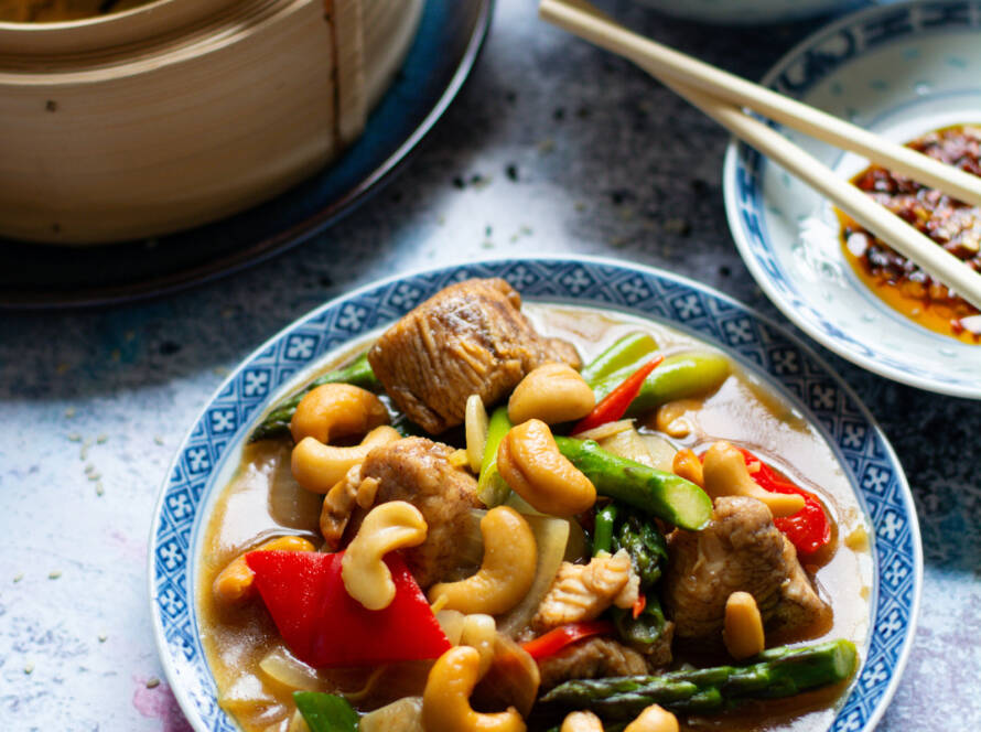 Chicken and cashew stir-fry with vegetables, served with rice and steamed pak choi
